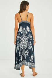 Model Madeline wearing size S of the Zari Sundress in colour Navy (Blue), from the back