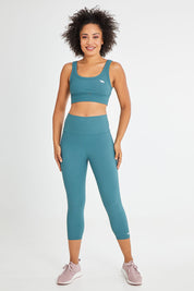 Model Olivia wearing size 10 of the Scoop It Up Sports Bra in colour Sage (Green), from the front, showing the whole outfit