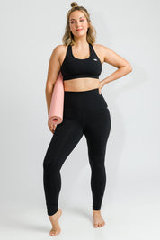 Model Jess wearing size 14 of the No Bounce Sports Bra in colour Black (Black), from the front, showing the whole outfit