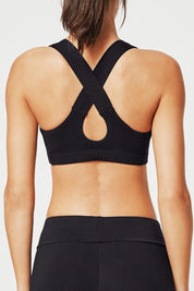 A model wearing the Power Up Cross Back Sports Bra in colour Black (Black), from the back