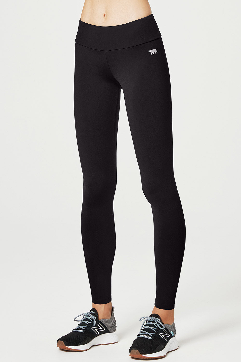 A model wearing the High Rise Full Length Tight in colour Black (Black), from the front, cropped image