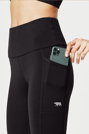 A model wearing the Ab Waisted Power Moves Pockets Full Length Tight in colour Black (Black), from the front, cropped image
