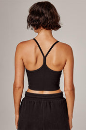 A model wearing the Dharma Long Line Rib Sports Bra in colour Black (Black), from the back