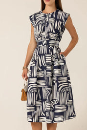 A model wearing the Clermont Cotton Fit And Flare Dress in colour Navy (Blue), from the front, cropped image