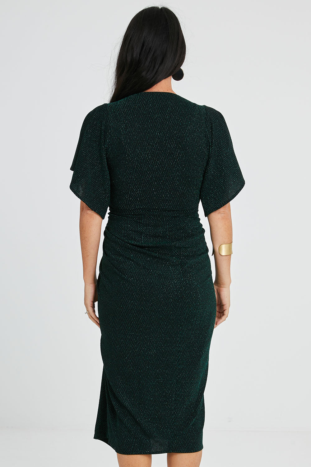 Model Katie wearing size 10 of the Emporium Dress in colour Emerald (Green), from the back