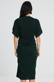 Model Katie wearing size 10 of the Emporium Dress in colour Emerald (Green), from the back