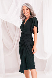 Model Luisa wearing size 10 of the Emporium Dress in colour Emerald (Green), from the front, cropped image
