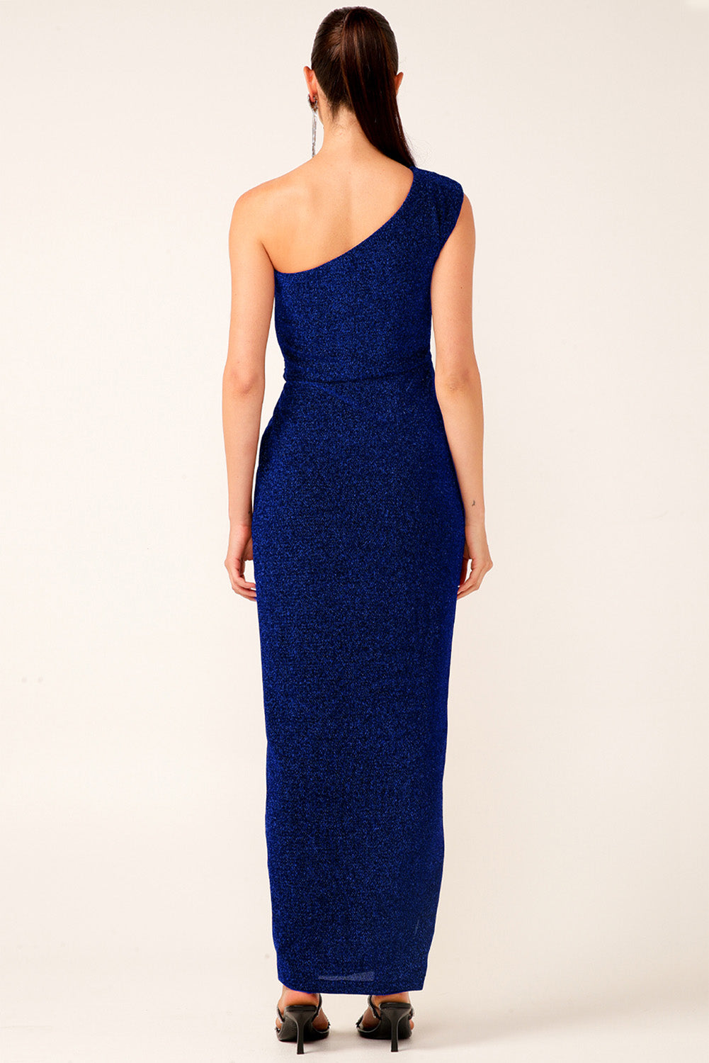 A model wearing the Valedictory Dress in colour Sapphire (Blue), from the back