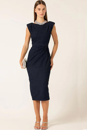 A model wearing the Celestial Dress in colour Navy (Blue), from the front, showing the whole outfit