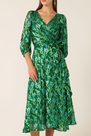 A model wearing the Orchid Wrap Dress in colour Green (Green), from the front, cropped image