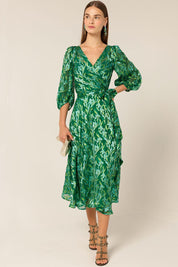 A model wearing the Orchid Wrap Dress in colour Green (Green), from the front, showing the whole outfit