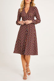 Model Alice wearing size 10 of the Auriga Dress in colour Ruby (Red), from the front, cropped image