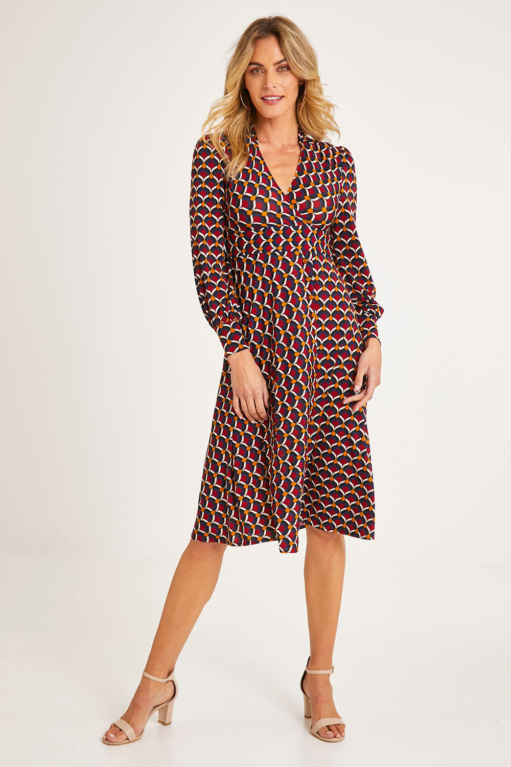 Model Alice wearing size 10 of the Auriga Dress in colour Ruby (Red), from the front, showing the whole outfit