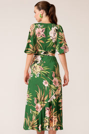 A model wearing the Chambord Wrap Midi Dress in colour Green (Green), from the back
