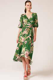 A model wearing the Chambord Wrap Midi Dress in colour Green (Green), from the front, showing the whole outfit