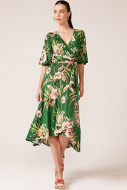 A model wearing the Chambord Wrap Midi Dress in colour Green (Green), from the front, showing the whole outfit