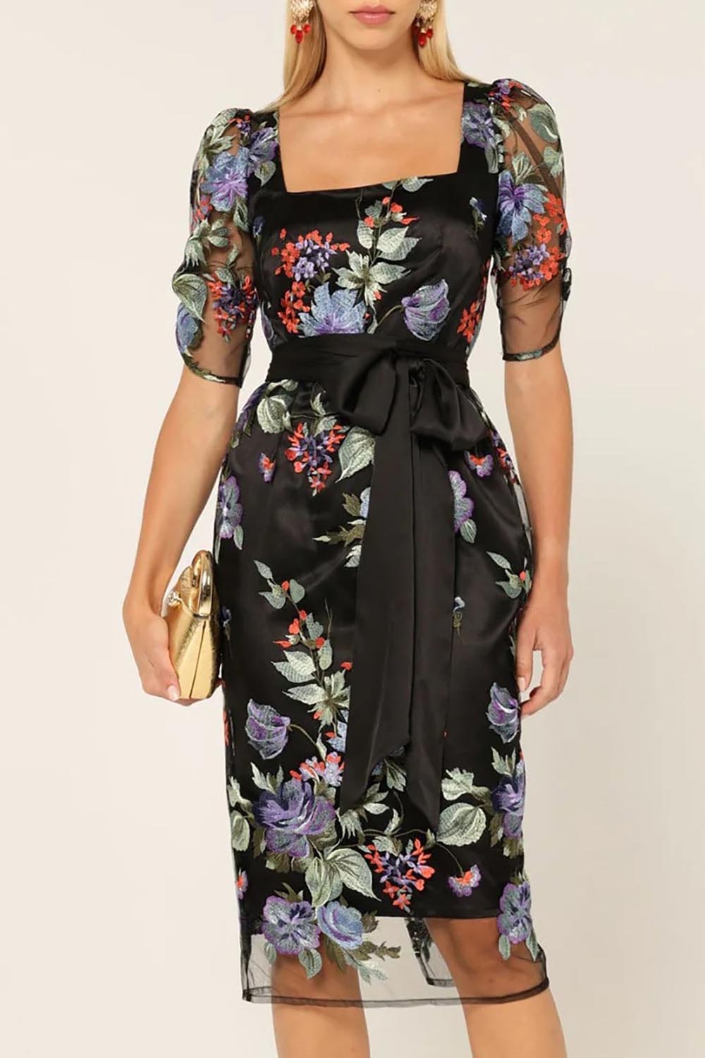 A model wearing the Mont Tombe Dress in colour Floral (Black), from the front, cropped image