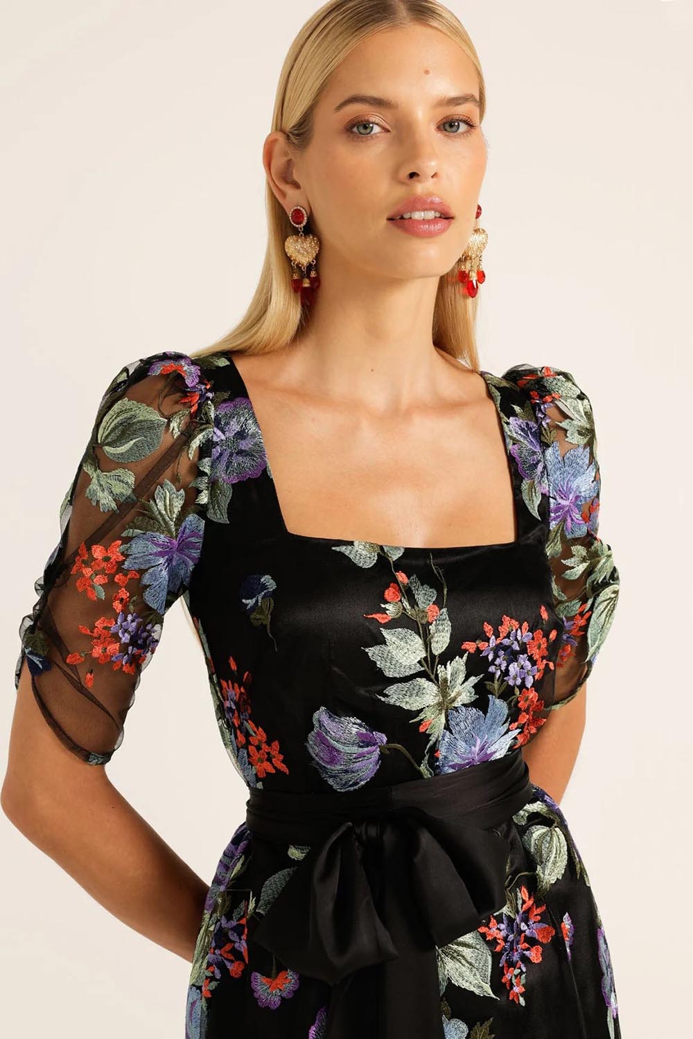 A model wearing the Mont Tombe Dress in colour Floral (Black), from the front, cropped image