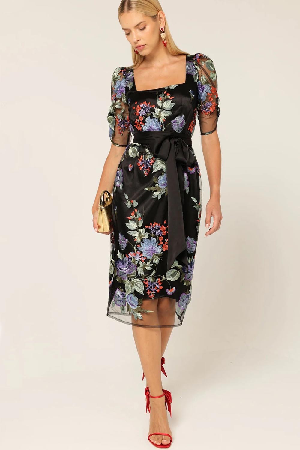 A model wearing the Mont Tombe Dress in colour Floral (Black), from the front, showing the whole outfit
