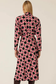 A model wearing the Rovel Dolman Dress in colour Magenta, from the back