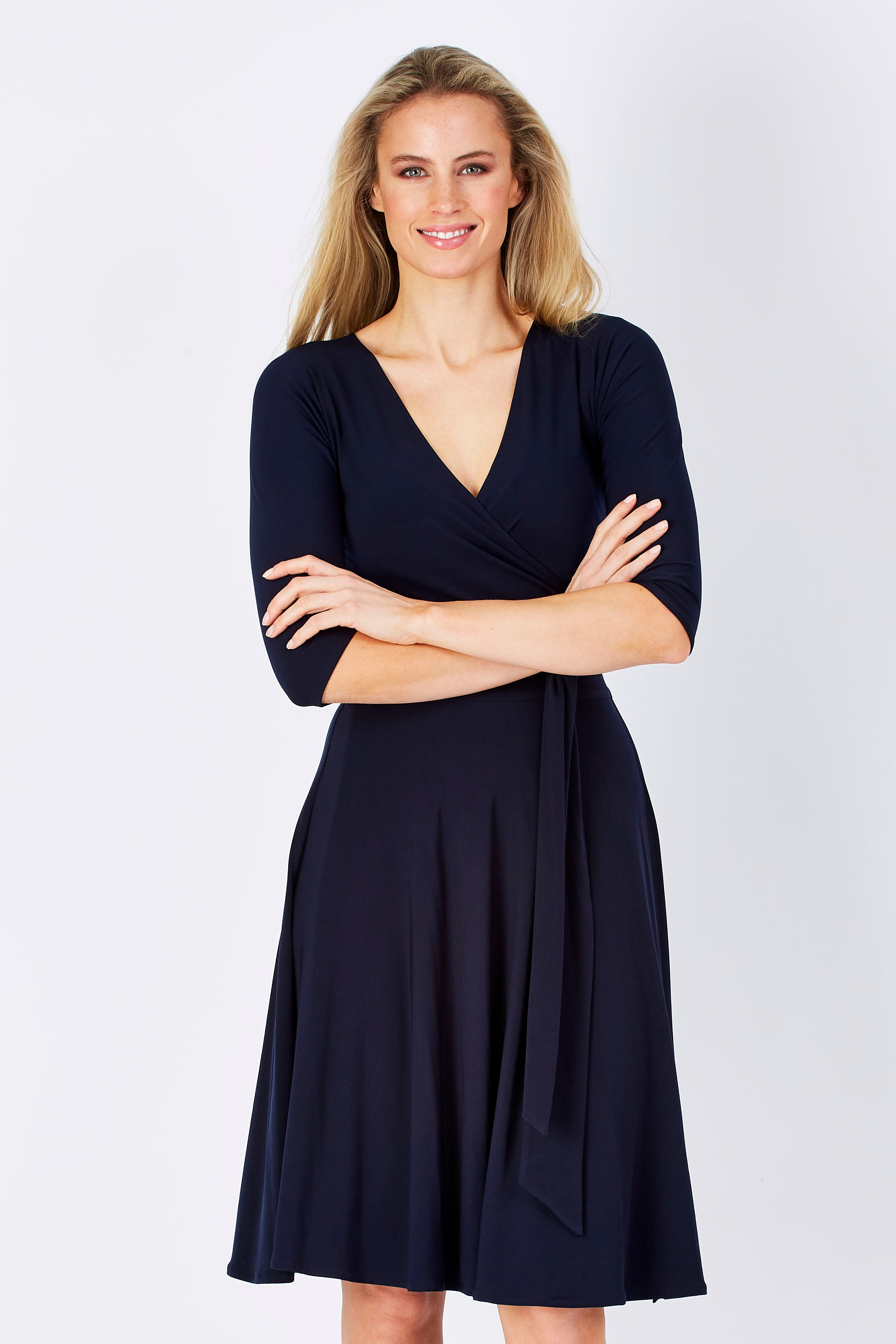 Model Maddy wearing size 10 of the Reverse Wrap Full Skirt Dress in colour Navy (Blue), from the front, cropped image