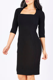 Model Maddy wearing size 10 of the Iris 3/4 Sleeve Dress in colour Black (Black), from the front, cropped image