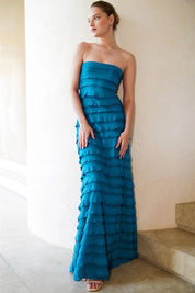 A model wearing the Maddison Maxi Ruffle Dress in colour Aqua (Blue), from the front, showing the whole outfit