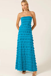 A model wearing the Maddison Maxi Ruffle Dress in colour Aqua (Blue), from the front, showing the whole outfit