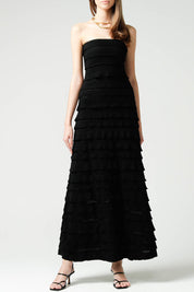 A model wearing the Maddison Maxi Ruffle Dress in colour Black (Black), from the front, cropped image