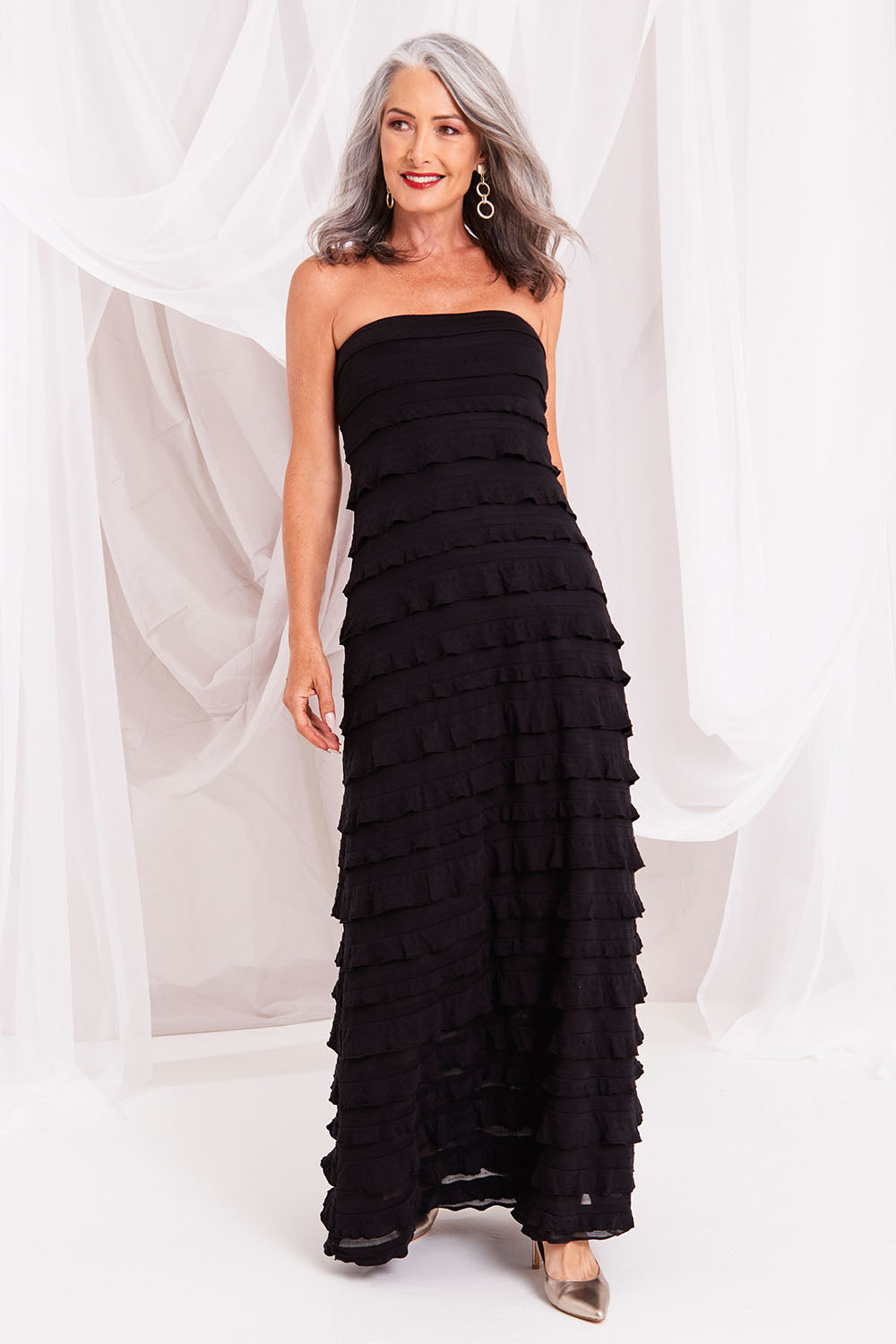 Model Luisa wearing size 10 of the Maddison Maxi Ruffle Dress in colour Black (Black), from the front, showing the whole outfit