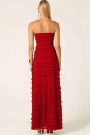 A model wearing the Maddison Maxi Ruffle Dress in colour Cherry (Red), from the back