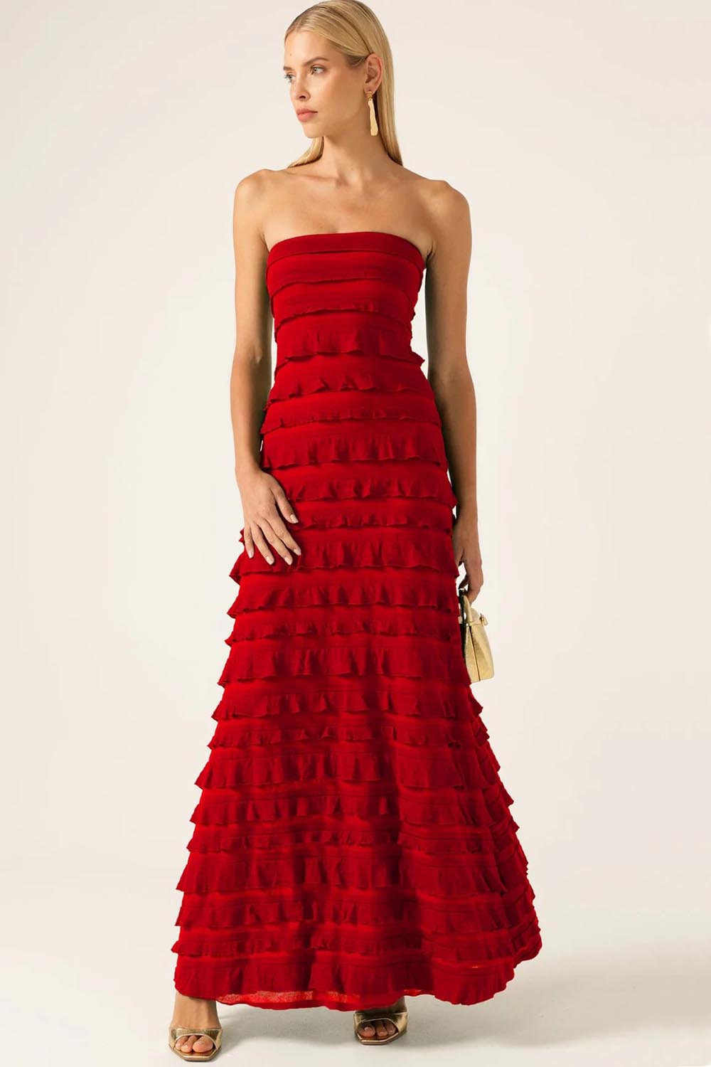 A model wearing the Maddison Maxi Ruffle Dress in colour Cherry (Red), from the front, showing the whole outfit