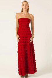 A model wearing the Maddison Maxi Ruffle Dress in colour Cherry (Red), from the front, showing the whole outfit