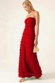 A model wearing the Maddison Maxi Ruffle Dress in colour Cherry (Red), from the front, showing the whole outfit