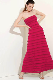 A model wearing the Maddison Maxi Ruffle Dress in colour Raspberry (Pink), from the front, showing the whole outfit