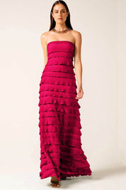 A model wearing the Maddison Maxi Ruffle Dress in colour Raspberry (Pink), from the front, showing the whole outfit