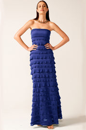 A model wearing the Maddison Maxi Ruffle Dress in colour Sapphire (Blue), from the front, showing the whole outfit