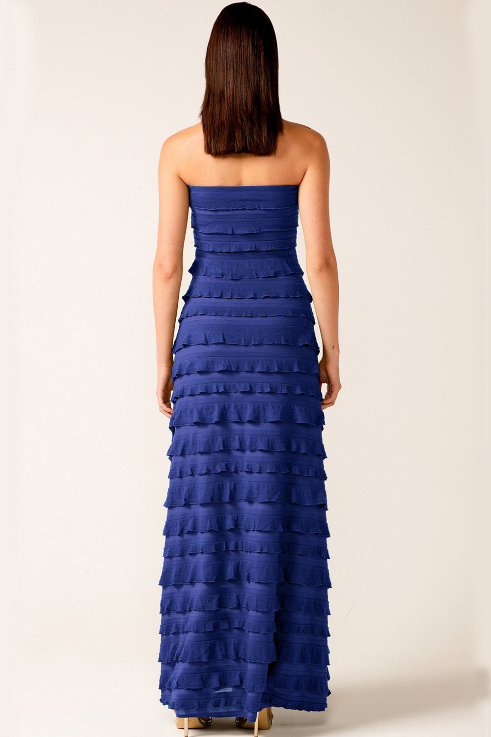 A model wearing the Maddison Maxi Ruffle Dress in colour Sapphire (Blue), from the front, showing the whole outfit