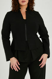 Model Maddy wearing size 16 of the Front Zip Peplum Jacket in colour Black (Black), from the front, cropped image
