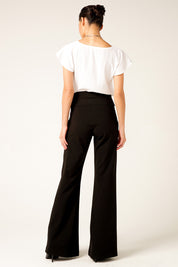 A model wearing the Classic Trouser in colour Black (Black), from the back