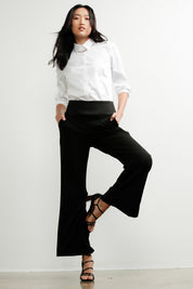 A model wearing the Classic Trouser in colour Black (Black), from the front, showing the whole outfit