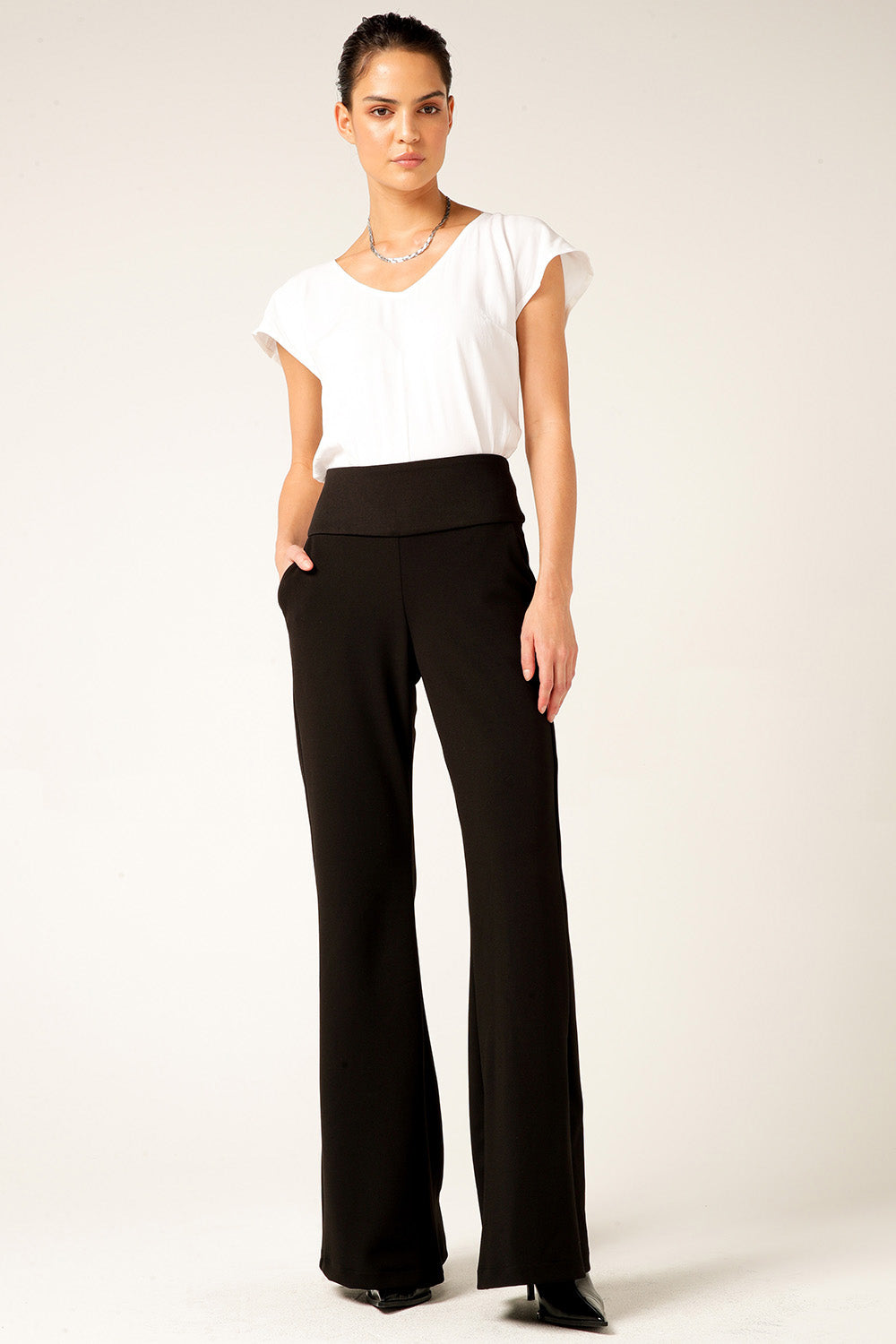 A model wearing the Classic Trouser in colour Black (Black), from the front, showing the whole outfit