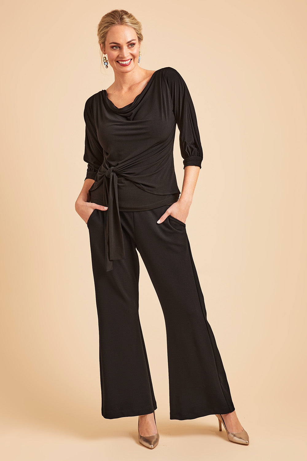 Model Grace wearing size 10 of the Classic Trouser in colour Black (Black), from the front, showing the whole outfit