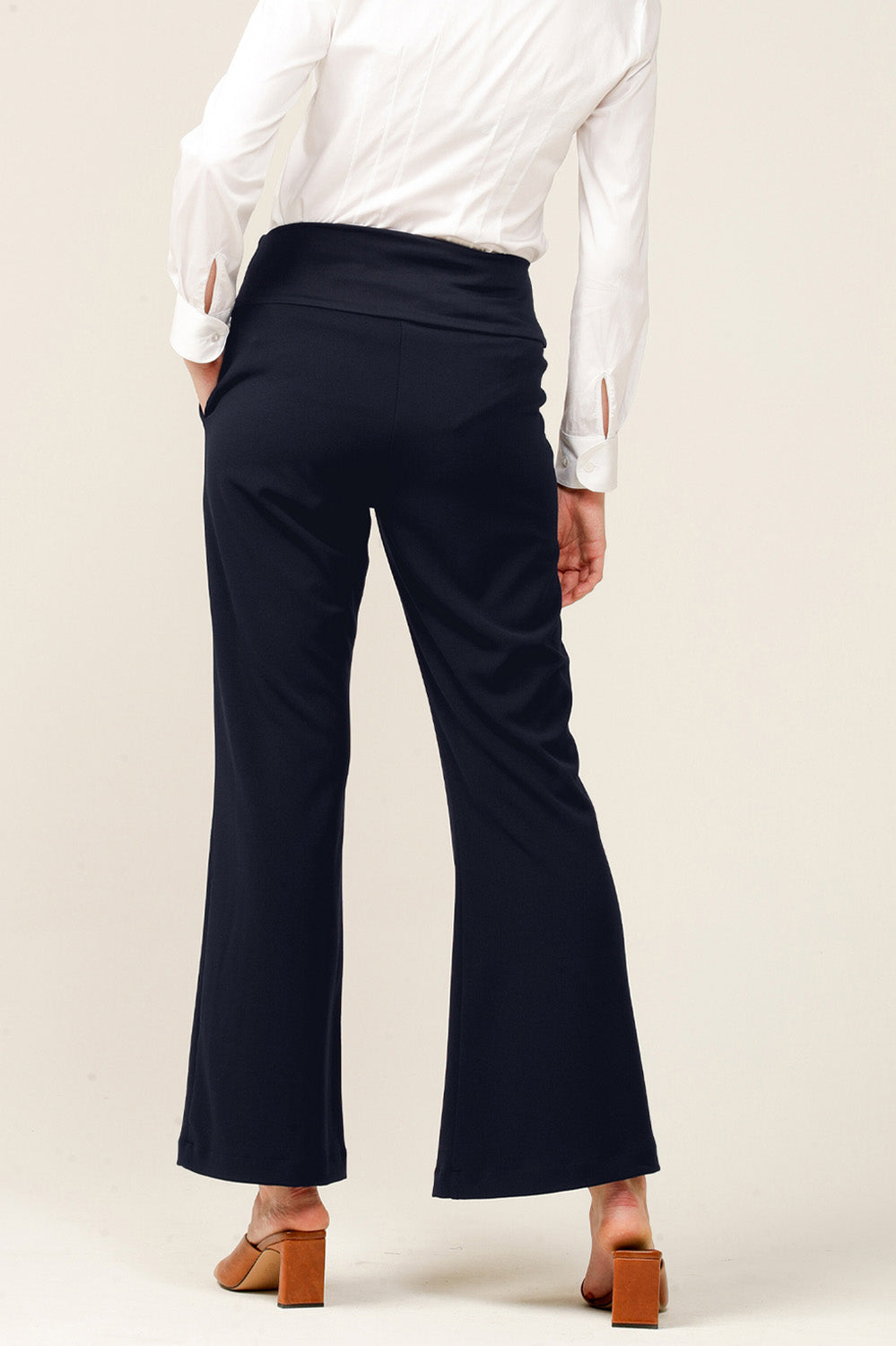 A model wearing the Classic Trouser in colour Navy (Blue), from the back