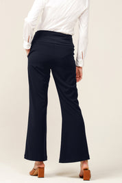 A model wearing the Classic Trouser in colour Navy (Blue), from the back