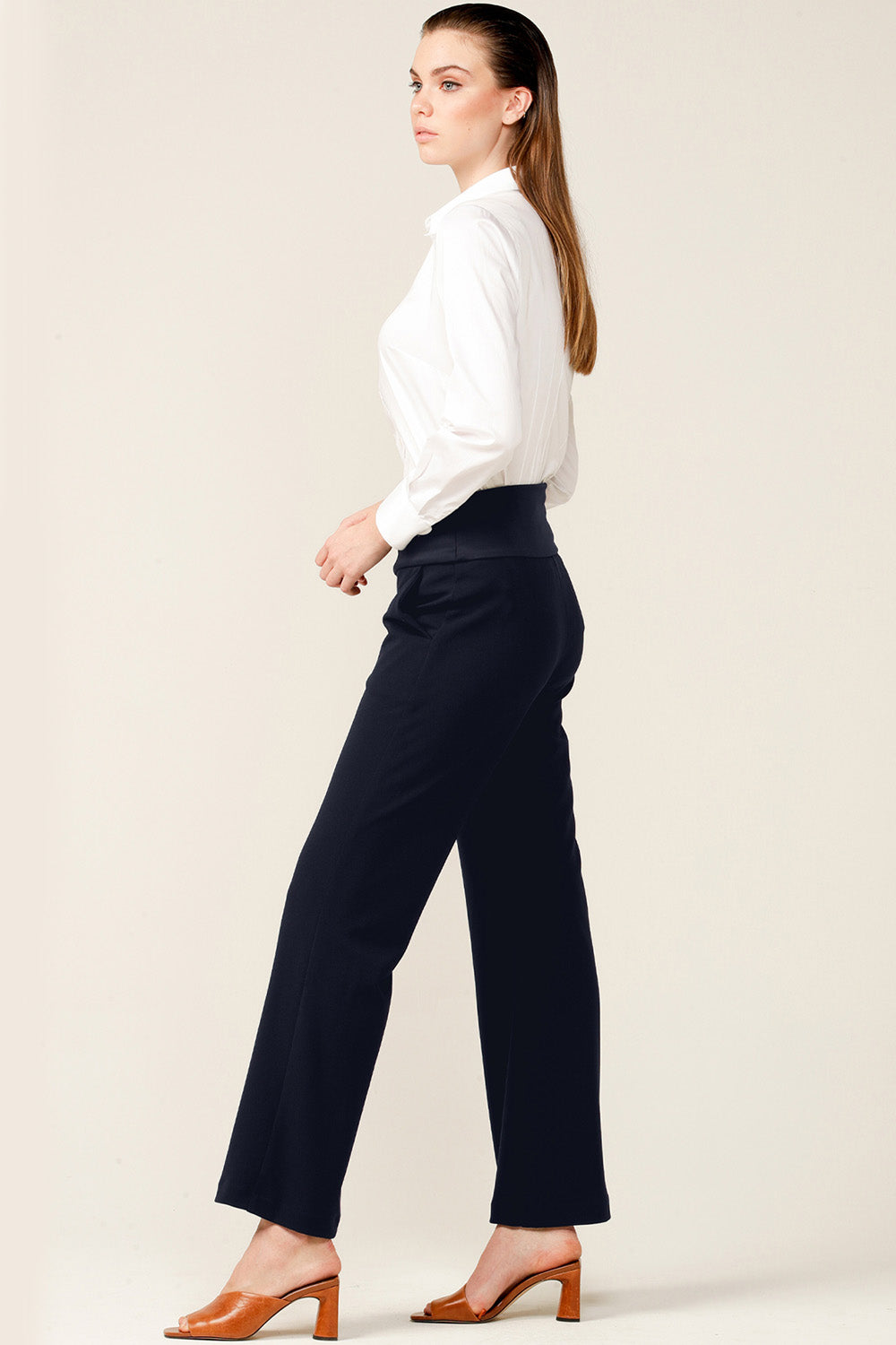 A model wearing the Classic Trouser in colour Navy (Blue), from the front, showing the whole outfit