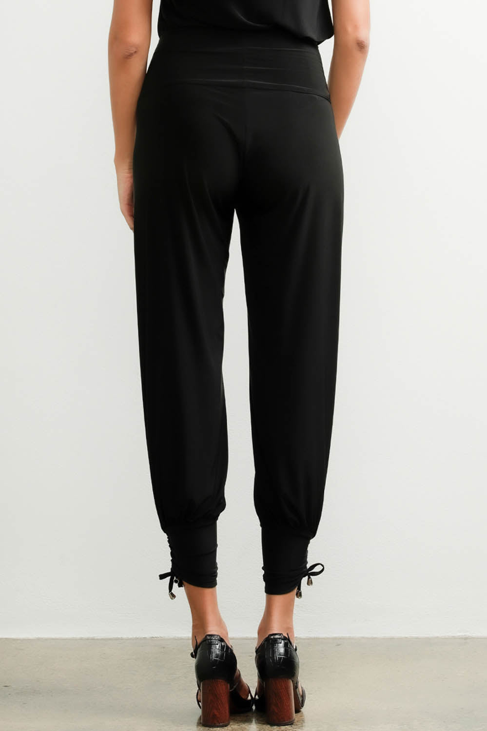 A model wearing the Harem Pant in colour Black (Black), from the back