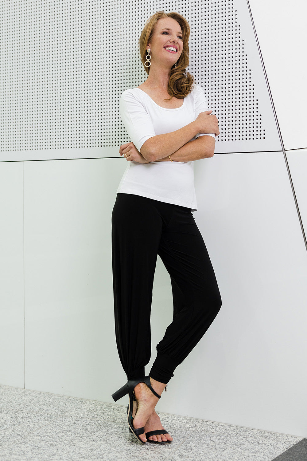 Model Katie wearing size 10 of the Harem Pant in colour Black (Black), from the front, showing the whole outfit