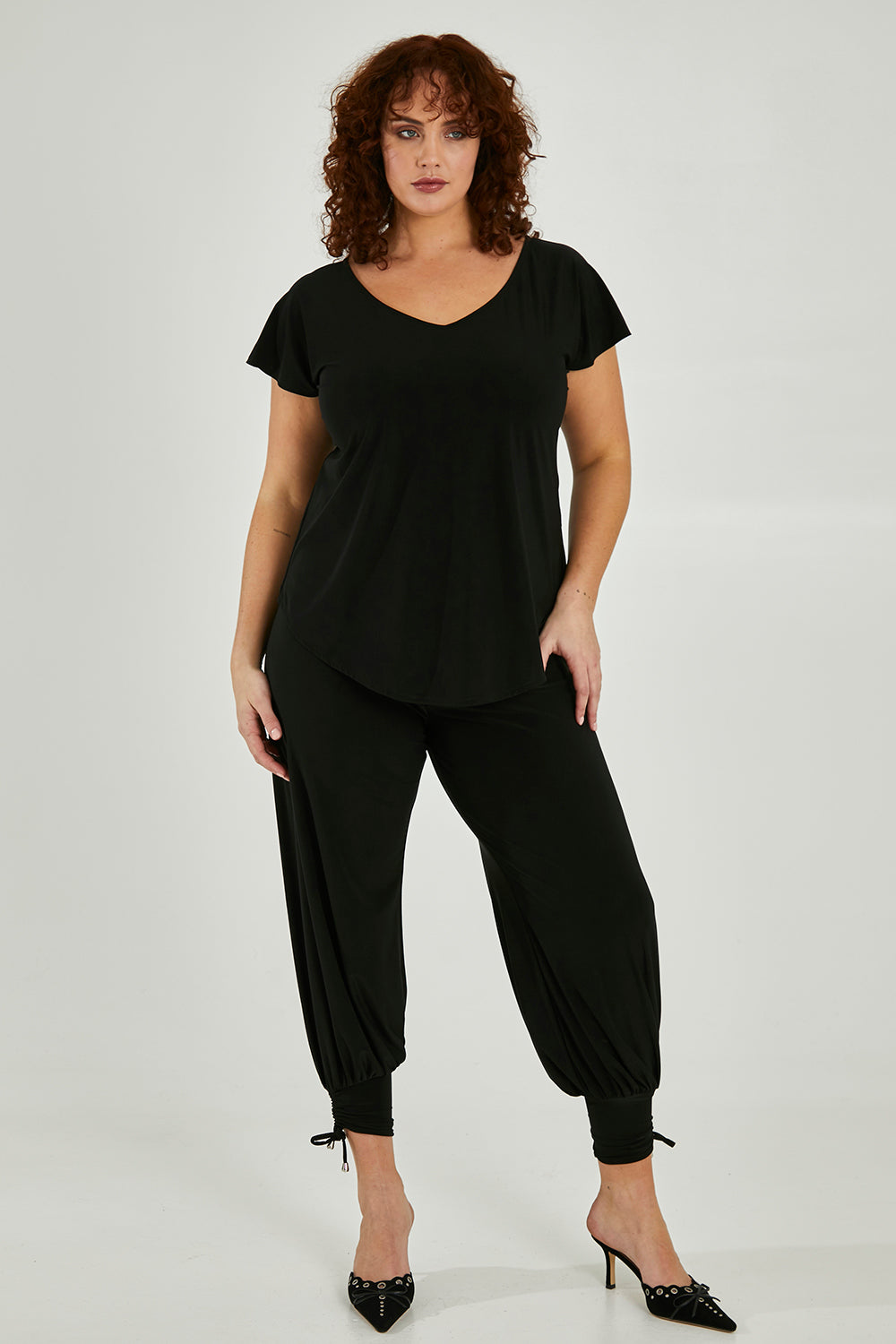 Model Maddy wearing size 16 of the Harem Pant in colour Black (Black), from the front, showing the whole outfit