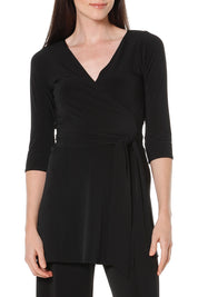 A model wearing the Turn around Tunic in colour Black (Black), from the front, cropped image
